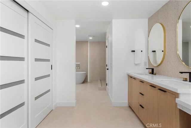 24705 Queens Ct, Laguna Niguel, CA 92677 - full bathroom featuring double vanity, a freestanding tub, recessed lighting, and baseboards