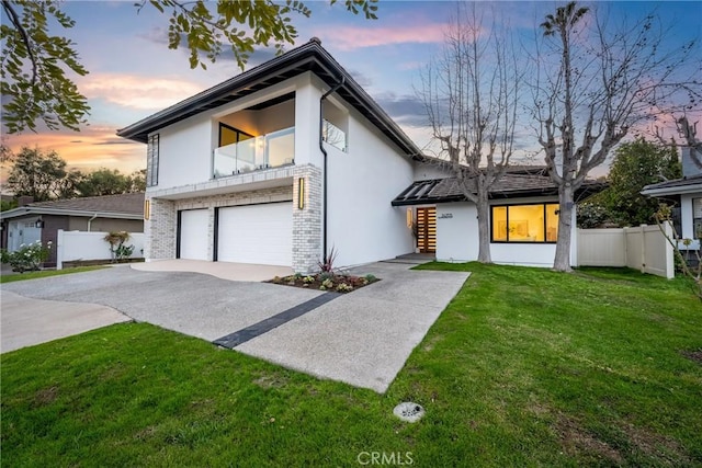 24705 Queens Ct, Laguna Niguel, CA 92677 - view of front of home featuring a garage, driveway, stucco siding, a balcony, and brick siding