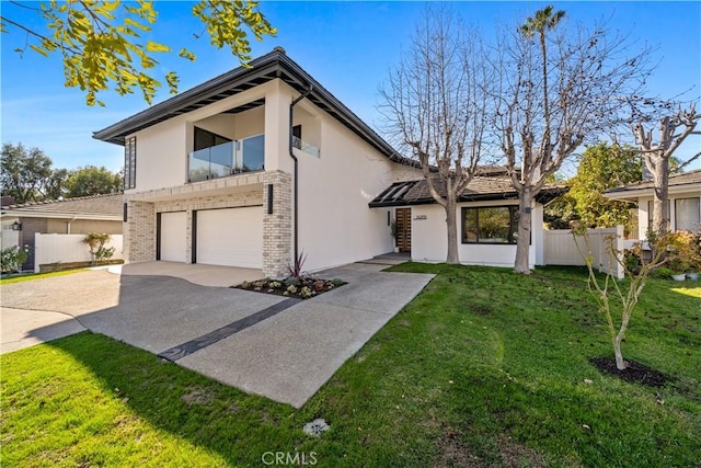 mid-century inspired home featuring stucco siding, fence, driveway, and a garage