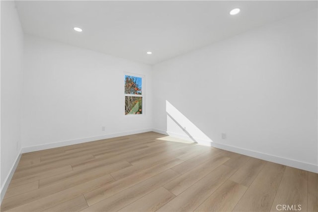 unfurnished room featuring recessed lighting, baseboards, and light wood finished floors