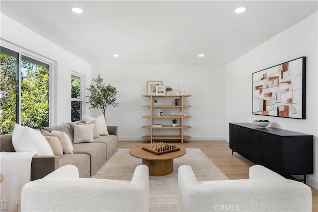 living area featuring recessed lighting, light wood-style flooring, and baseboards