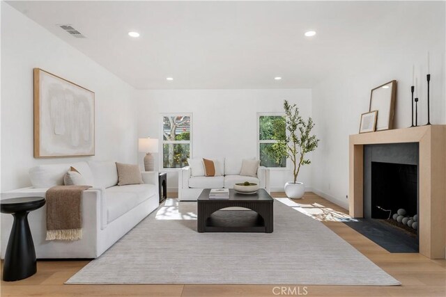 24705 Queens Ct, Laguna Niguel, CA 92677 - living area with wood finished floors, a fireplace with flush hearth, and recessed lighting