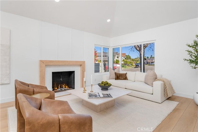 24705 Queens Ct, Laguna Niguel, CA 92677 - living area with light wood-type flooring, a warm lit fireplace, baseboards, and recessed lighting