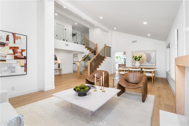 24705 Queens Ct, Laguna Niguel, CA 92677 - living room with stairs, light wood finished floors, recessed lighting, high vaulted ceiling, and baseboards