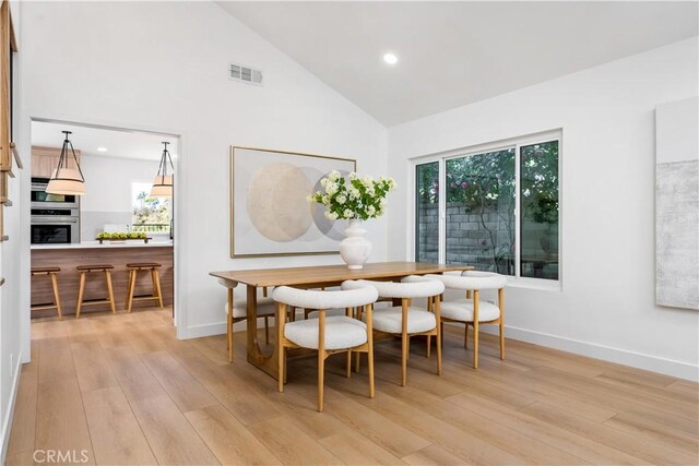 24705 Queens Ct, Laguna Niguel, CA 92677 - dining area with light wood-style floors, high vaulted ceiling, healthy amount of natural light, baseboards, and recessed lighting