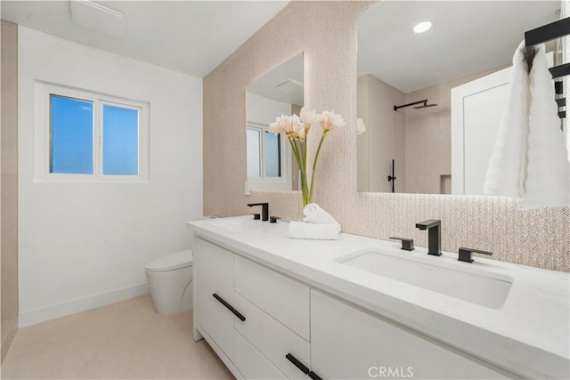 full bath with double vanity, toilet, walk in shower, and a sink