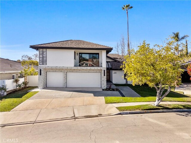 24705 Queens Ct, Laguna Niguel, CA 92677 - view of front of home featuring an attached garage, stucco siding, driveway, and brick siding
