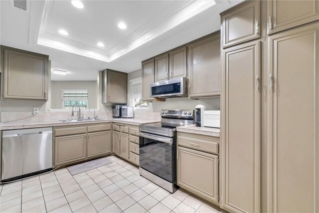 kitchen with appliances with stainless steel finishes, a sink, light countertops, recessed lighting, and visible vents