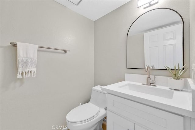 half bathroom with toilet and vanity