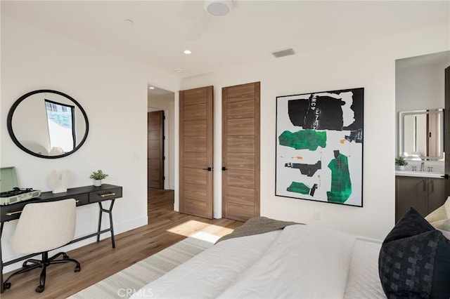 932 9th St, Manhattan Beach, CA 90266 - bedroom with wood finished floors, an office area, recessed lighting, a sink, and baseboards