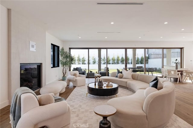 932 9th St, Manhattan Beach, CA 90266 - living room featuring light wood-style floors, baseboards, a glass covered fireplace, and recessed lighting