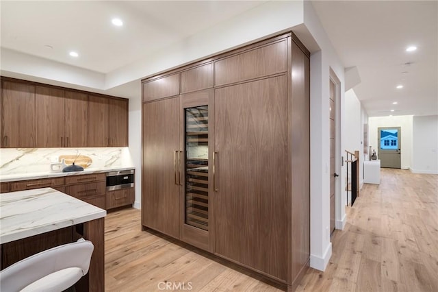 932 9th St, Manhattan Beach, CA 90266 - kitchen with recessed lighting, light wood finished floors, baseboards, and modern cabinets