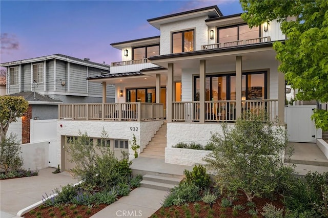 932 9th St, Manhattan Beach, CA 90266 - back of house with a porch, stairway, concrete driveway, fence, and a garage