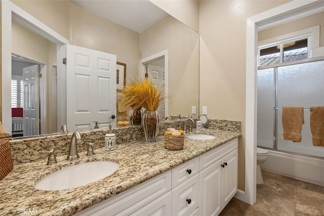 full bath featuring a sink, a healthy amount of sunlight, and toilet