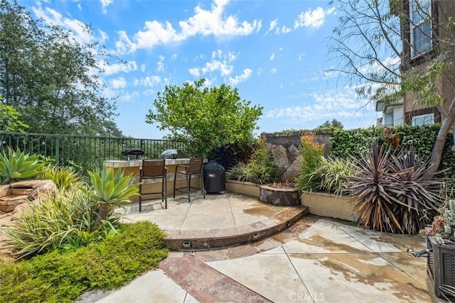 view of patio / terrace featuring a fenced backyard and outdoor dry bar