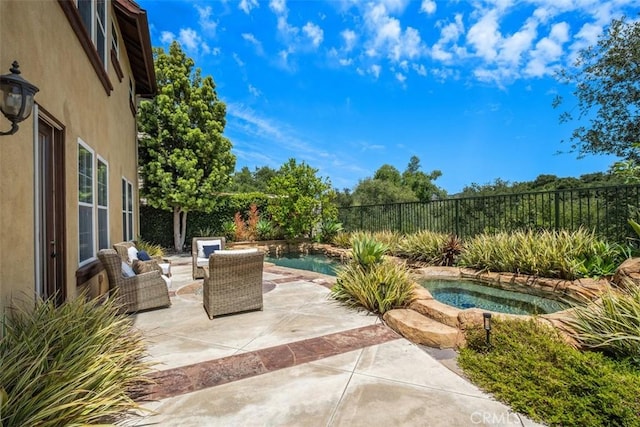view of swimming pool with a fenced backyard, a fenced in pool, an in ground hot tub, and a patio area