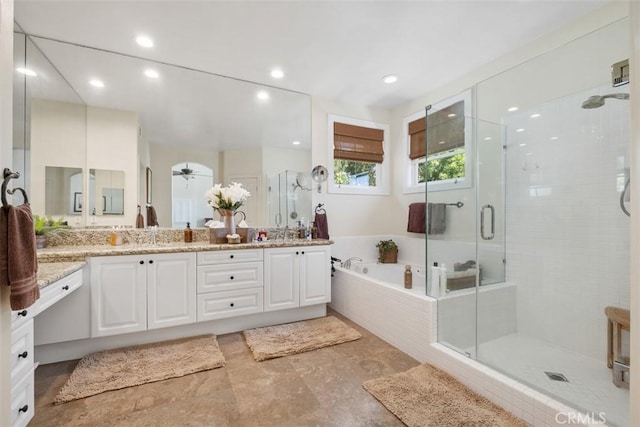 bathroom featuring a garden tub, double vanity, a stall shower, and recessed lighting