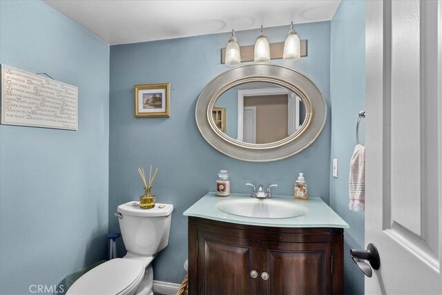 bathroom featuring vanity and toilet