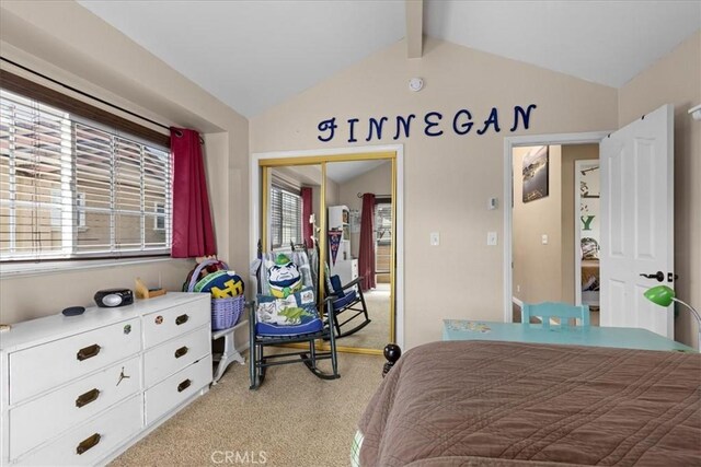 bedroom with lofted ceiling with beams, a closet, and light colored carpet