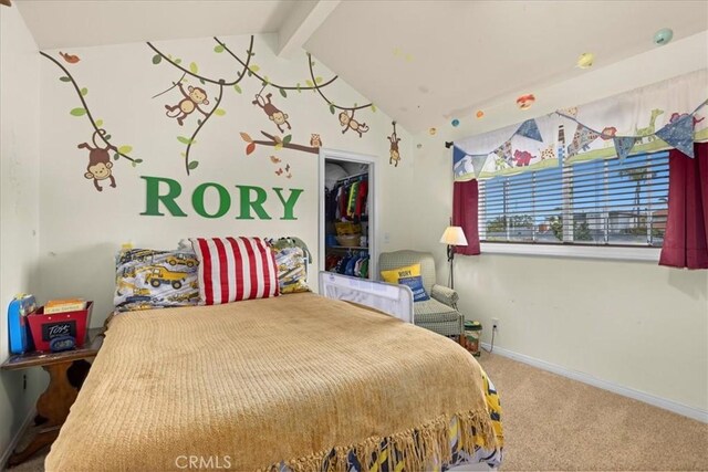 carpeted bedroom with baseboards, lofted ceiling with beams, and a closet