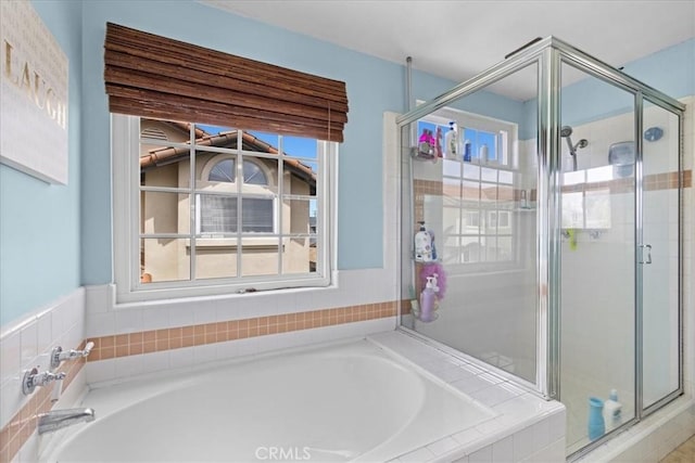 full bath with a stall shower and a bath