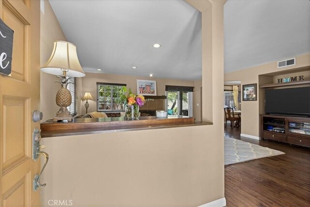 interior space featuring visible vents, wood finished floors, baseboards, ornate columns, and recessed lighting