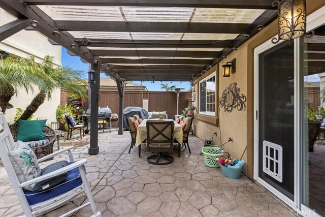 view of patio featuring a fenced backyard, an outdoor hangout area, a pergola, outdoor dining space, and a grill