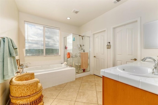 full bath with a sink, a garden tub, a stall shower, and a healthy amount of sunlight