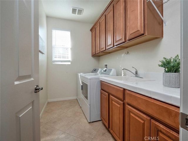22620 Dragonfly Ct, Saugus, CA 91350 - washroom with separate washer and dryer, cabinet space, and light tile patterned floors