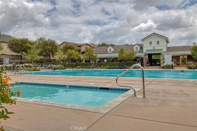 pool with fence and a patio area