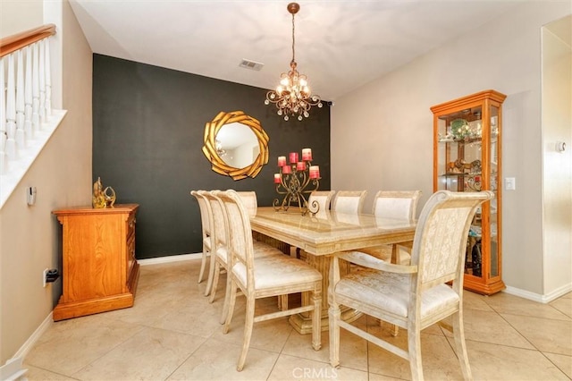 22620 Dragonfly Ct, Saugus, CA 91350 - dining space featuring a chandelier, light tile patterned floors, an accent wall, and stairway