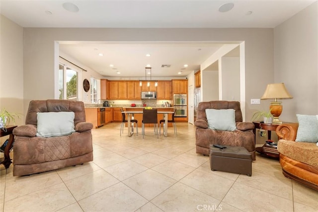 living room featuring light tile patterned flooring, recessed lighting, and visible vents