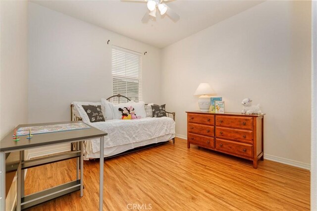bedroom with baseboards, ceiling fan, and wood finished floors
