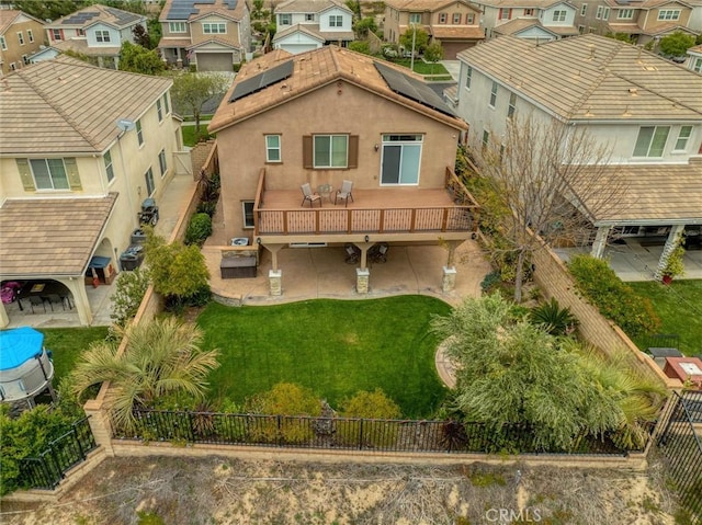 back of property featuring a residential view, outdoor dining space, and a fenced backyard