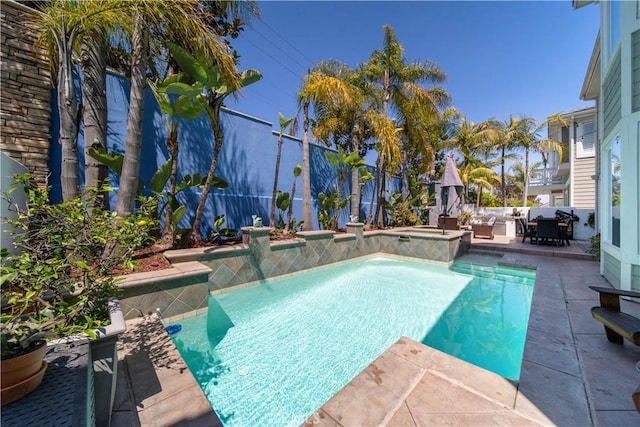 view of swimming pool with fence, outdoor dining area, a fenced in pool, a jacuzzi, and a patio area