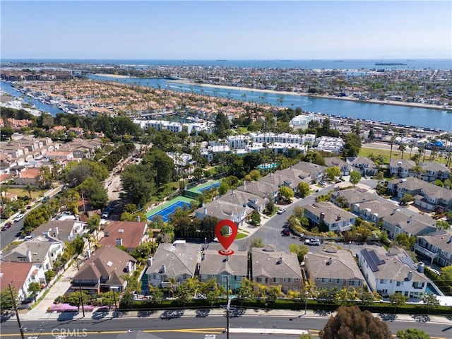 drone / aerial view featuring a residential view and a water view