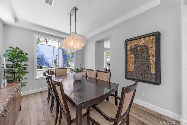 dining area featuring visible vents, baseboards, plenty of natural light, and light wood-type flooring