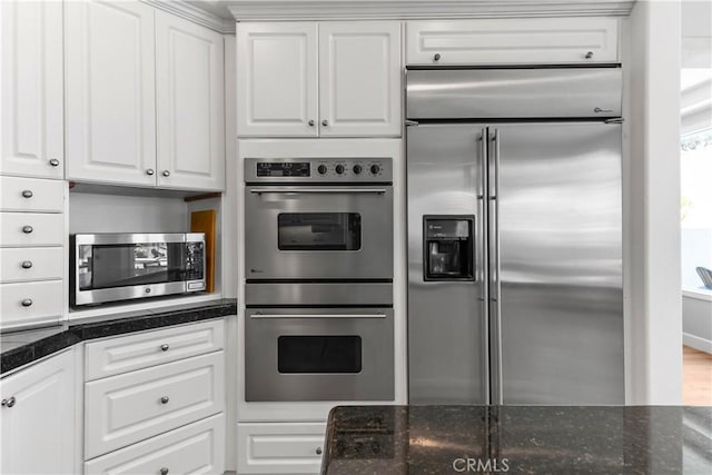 kitchen with appliances with stainless steel finishes and white cabinetry