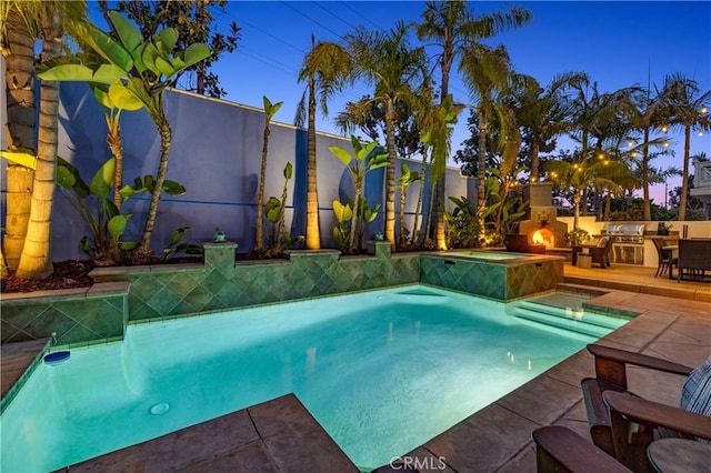 pool featuring a patio and an in ground hot tub