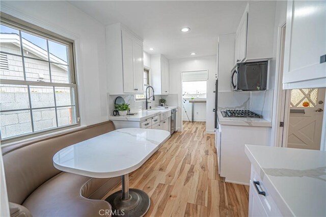 206 Calle De Sirenas, Redondo Beach, CA 90277 - kitchen with light wood-style flooring, white cabinets, stainless steel appliances, tasteful backsplash, and recessed lighting