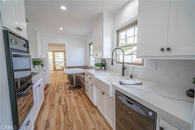 206 Calle De Sirenas, Redondo Beach, CA 90277 - kitchen featuring black appliances, light wood finished floors, white cabinetry, a sink, and recessed lighting