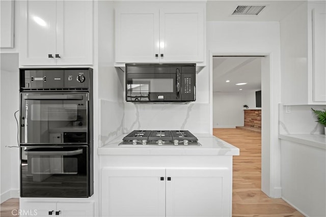 206 Calle De Sirenas, Redondo Beach, CA 90277 - kitchen featuring black appliances, light wood-type flooring, white cabinets, and light countertops