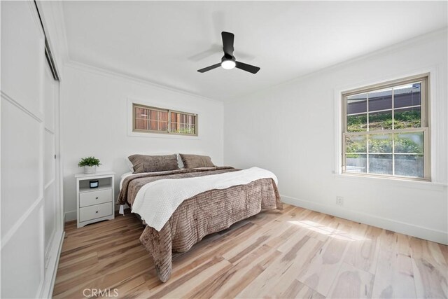 206 Calle De Sirenas, Redondo Beach, CA 90277 - bedroom featuring ornamental molding, light wood-style floors, baseboards, a ceiling fan, and a closet