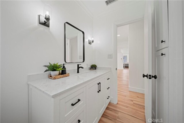 206 Calle De Sirenas, Redondo Beach, CA 90277 - bathroom featuring wood finished floors, crown molding, vanity, and baseboards