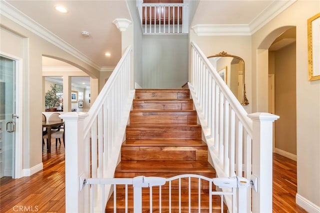34072 Lily Rd, Yucaipa, CA 92399 - stairway with arched walkways, wood finished floors, crown molding, recessed lighting, and baseboards
