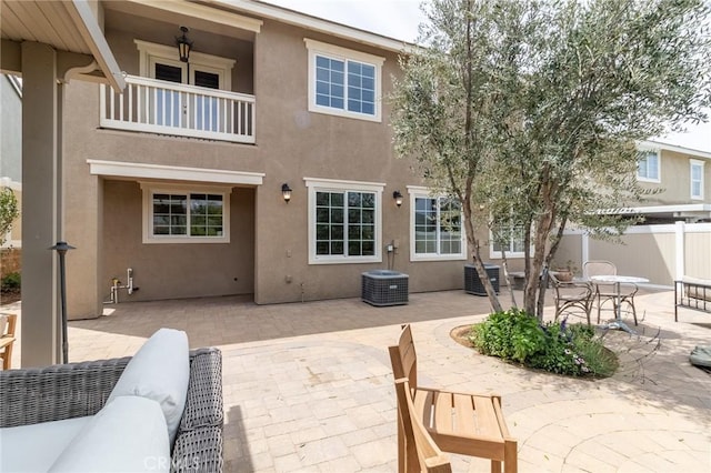 34072 Lily Rd, Yucaipa, CA 92399 - back of house with stucco siding, central AC, a patio, and fence
