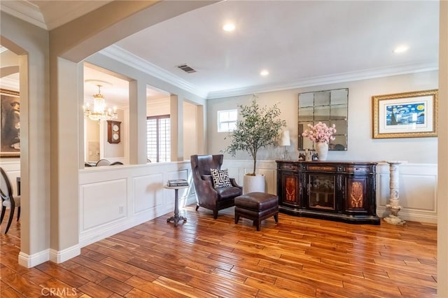 34072 Lily Rd, Yucaipa, CA 92399 - sitting room with arched walkways, a decorative wall, hardwood / wood-style flooring, a wainscoted wall, and ornamental molding