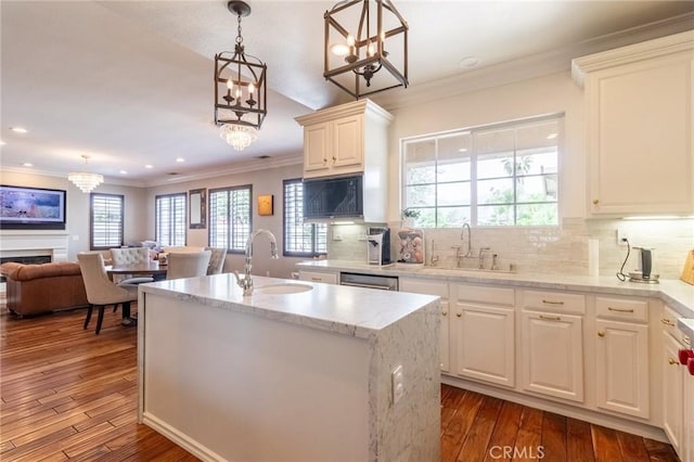 34072 Lily Rd, Yucaipa, CA 92399 - kitchen featuring a sink, open floor plan, dark wood-style floors, crown molding, and decorative light fixtures