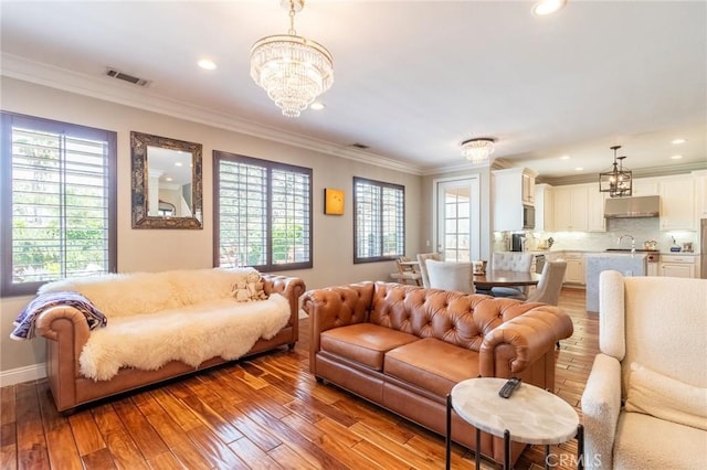34072 Lily Rd, Yucaipa, CA 92399 - living area with a chandelier, healthy amount of natural light, ornamental molding, light wood-style flooring, and recessed lighting