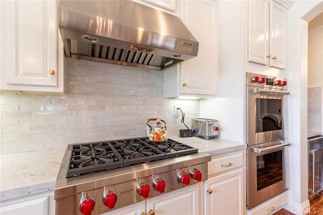 34072 Lily Rd, Yucaipa, CA 92399 - kitchen featuring under cabinet range hood, stainless steel double oven, gas stovetop, and white cabinets